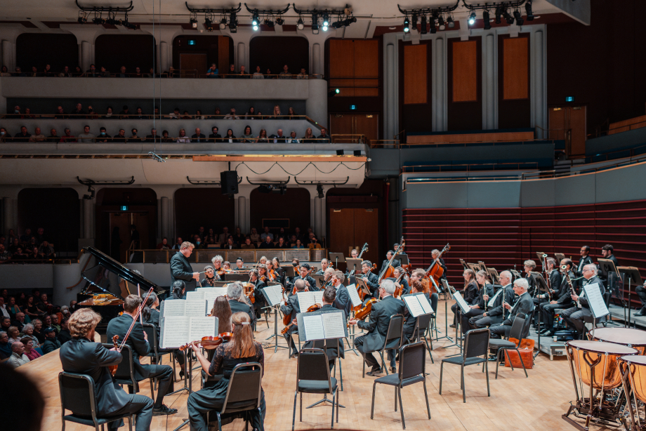 a full crowd of spectators enjoying a performance by the Calgary Philharmonic Orchestra