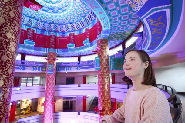 young girl admires the 70 foot decorative ceiling at the Calgary Chinese Cultural Centre
