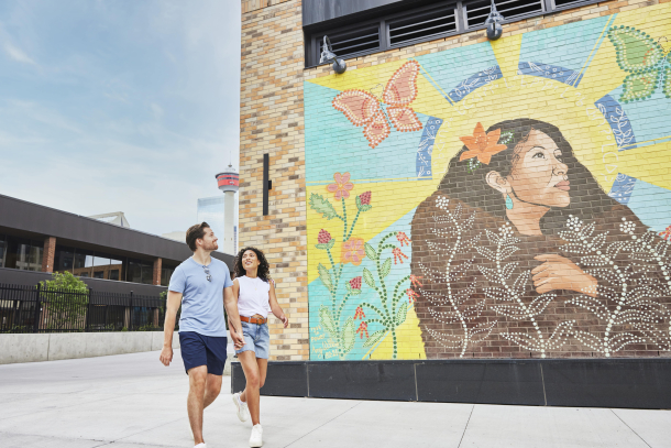a couple walking and enjoy a public art in calgary