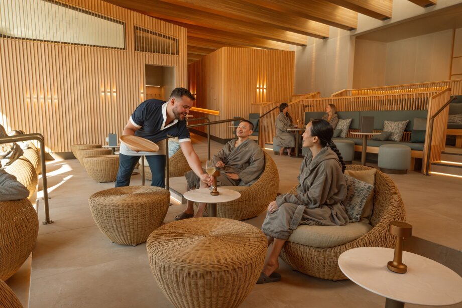 A couple look out a window from inside the BASIN wellness centre.