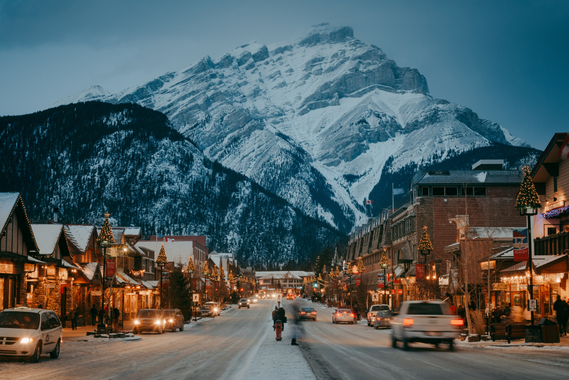 Banff Ave in winter, in the evening, mountains in the background in Banff National Park