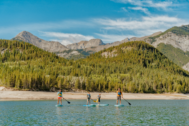 Family paddle boarding on Barrier Lake in Kananaskis Country