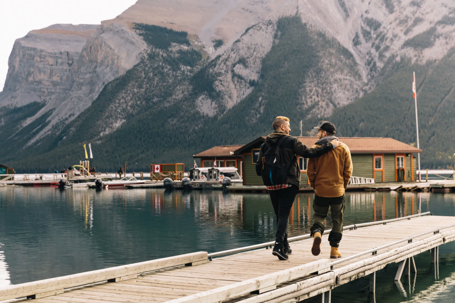 Two men walking along the dock at lake minnewanka