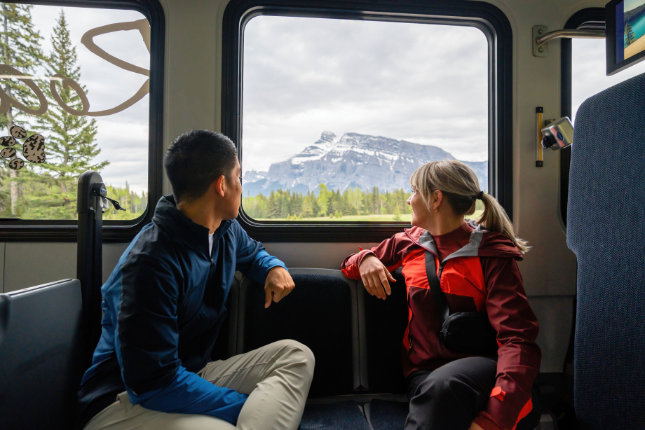 Couple looking out from a Roam Transit bus in Banff