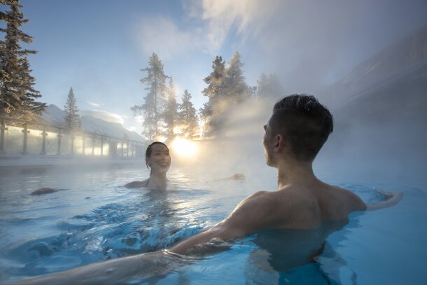 A couple relax and enjoy in the Upper Hot Springs in Banff National Park