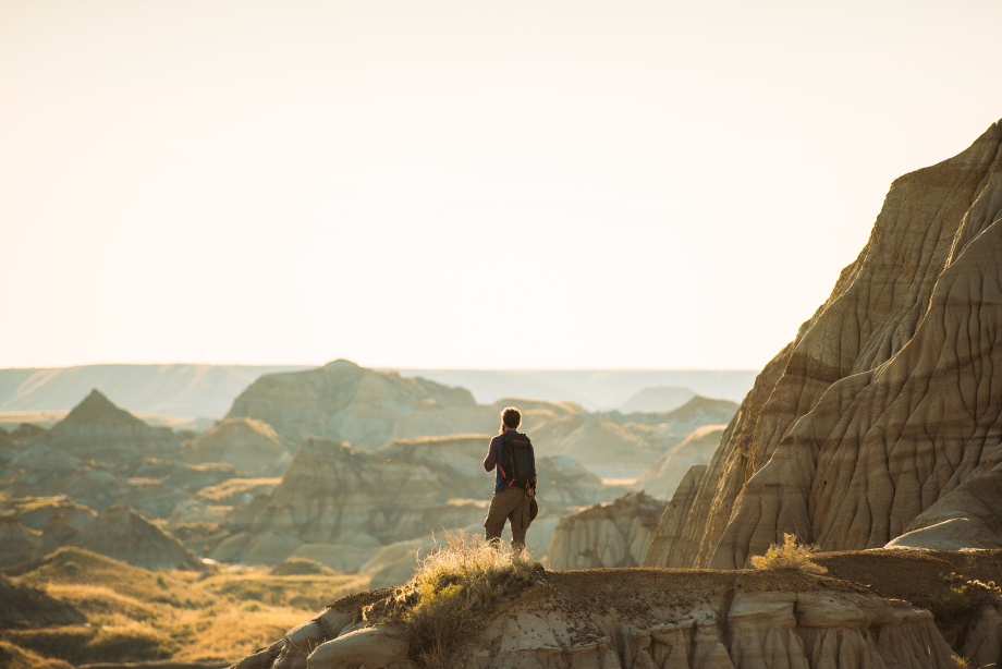 A person hiking through the badlands in Dinosaur Provincial Park