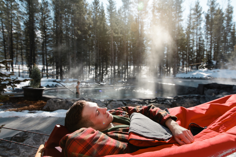 Man relaxing at the Nordic spa at the Pomeroy Kananaskis Mountain Lodge