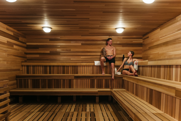 Couple enjoying the sauna at the Nordic Spa at Pomeroy Kananaskis Mountain Lodge