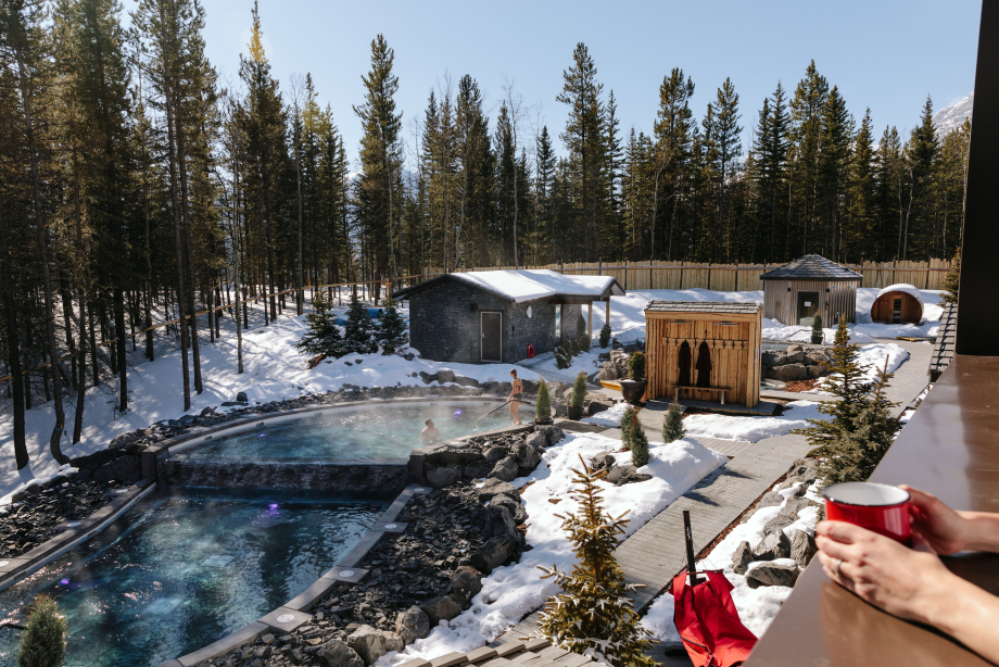 Scenic shot of the Nordic Spa outdoor pool and hot tub at the Pomeroy Kananaskis Mountain Lodge
