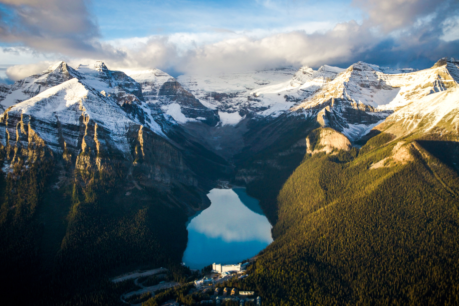 Aerial view of the Fairmont Chateau Lake Louise surrounded by mountains in Banff National Park