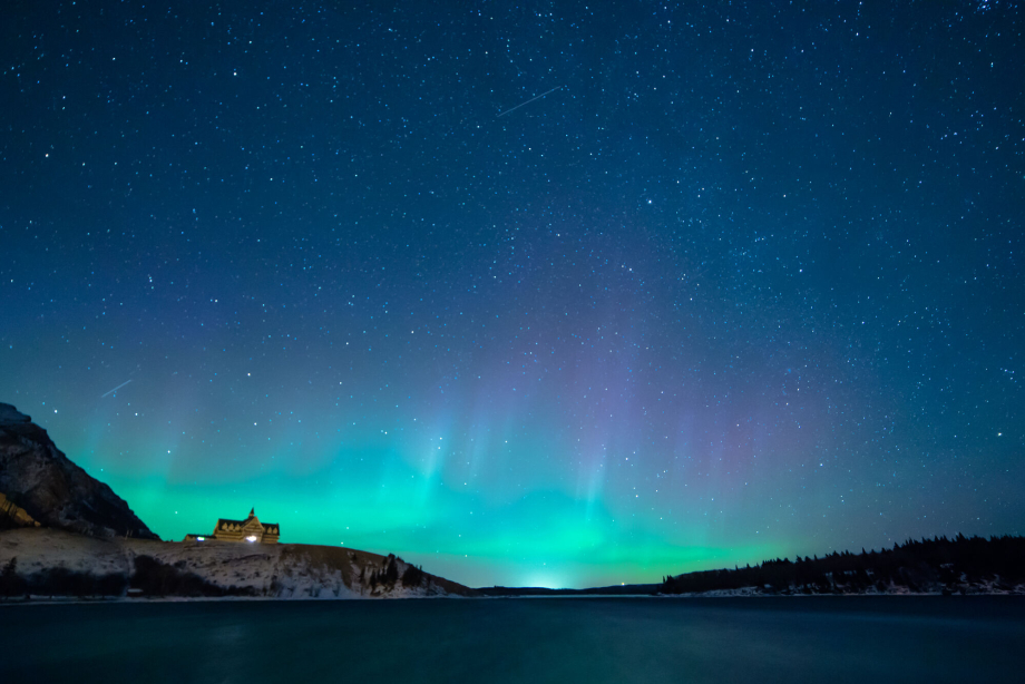 Northern lights in a starry night sky over the Prince of Wales Hotel in Waterton Lakes National Park