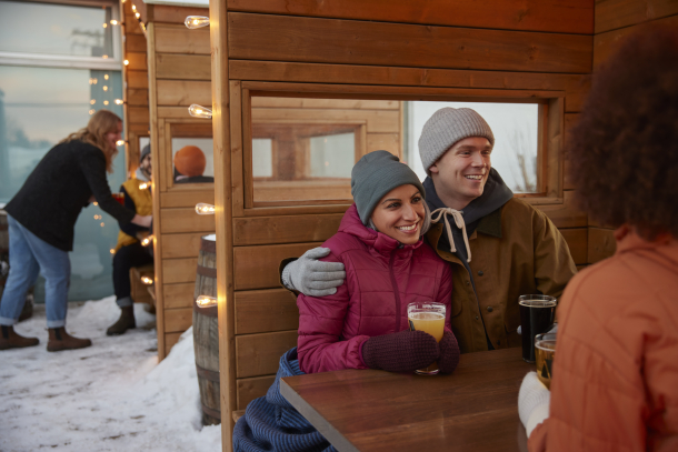 friends on the Cabin Brewing patio during winter