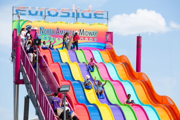 Kids playing at The Great FUNtier rides at Calgary Stampede