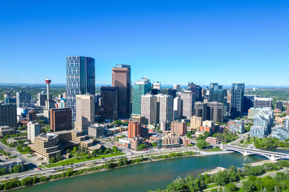 Aerial view of the Bow River and Calgary skyline in spring.