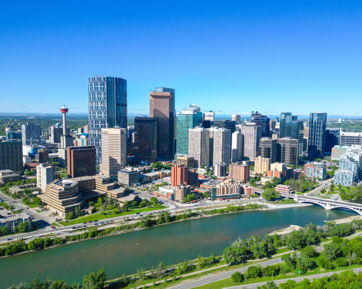 Aerial view of the Bow River and Calgary skyline in spring.