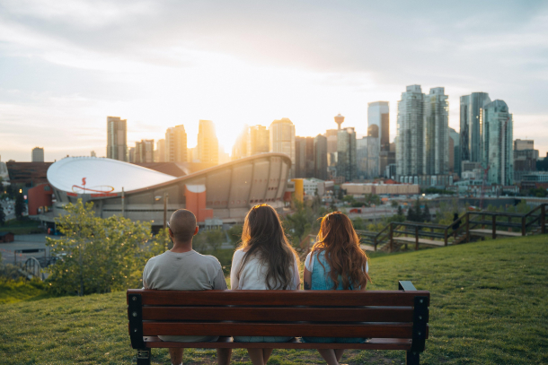 Two females and a male enjoying the sunset at Scotsman's Hill on a summer evening