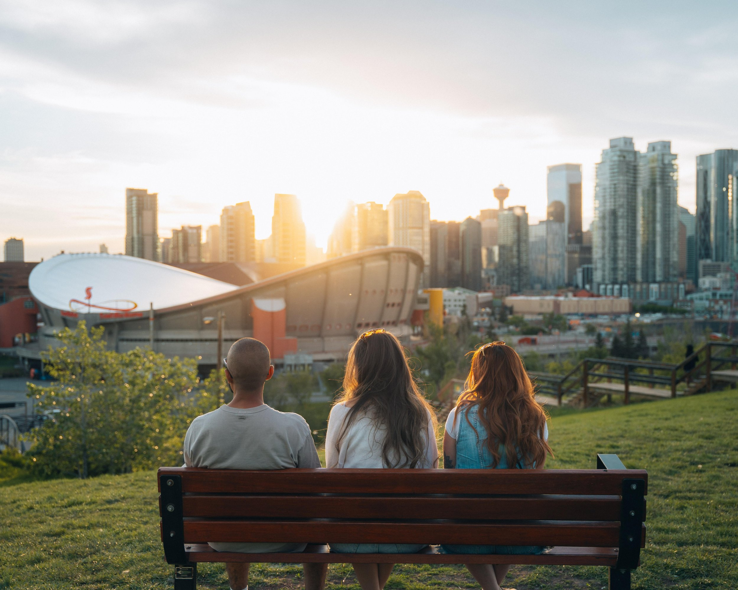 Two females and a male enjoying the sunset at Scotsman's Hill on a summer evening