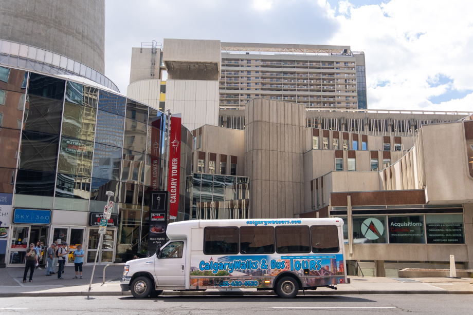 CalgaryWalks & Bus Tours bus in front of Calgary Tower