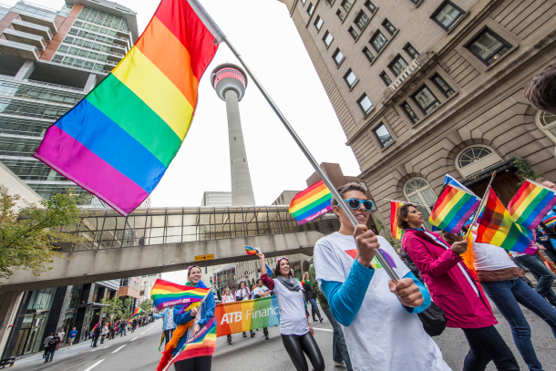 Pride flag waving in front of the Calgary Tower as part of the Calgary Pride Parade in downtown