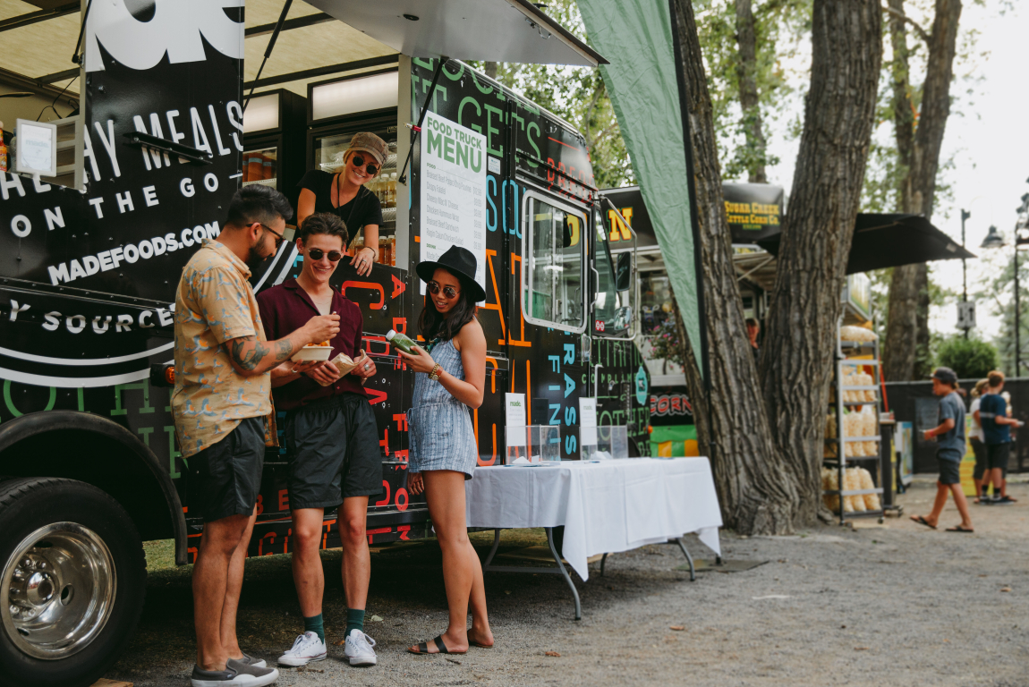 A group of friends ordering food from a food truck at the Calgary Folk Music Festival