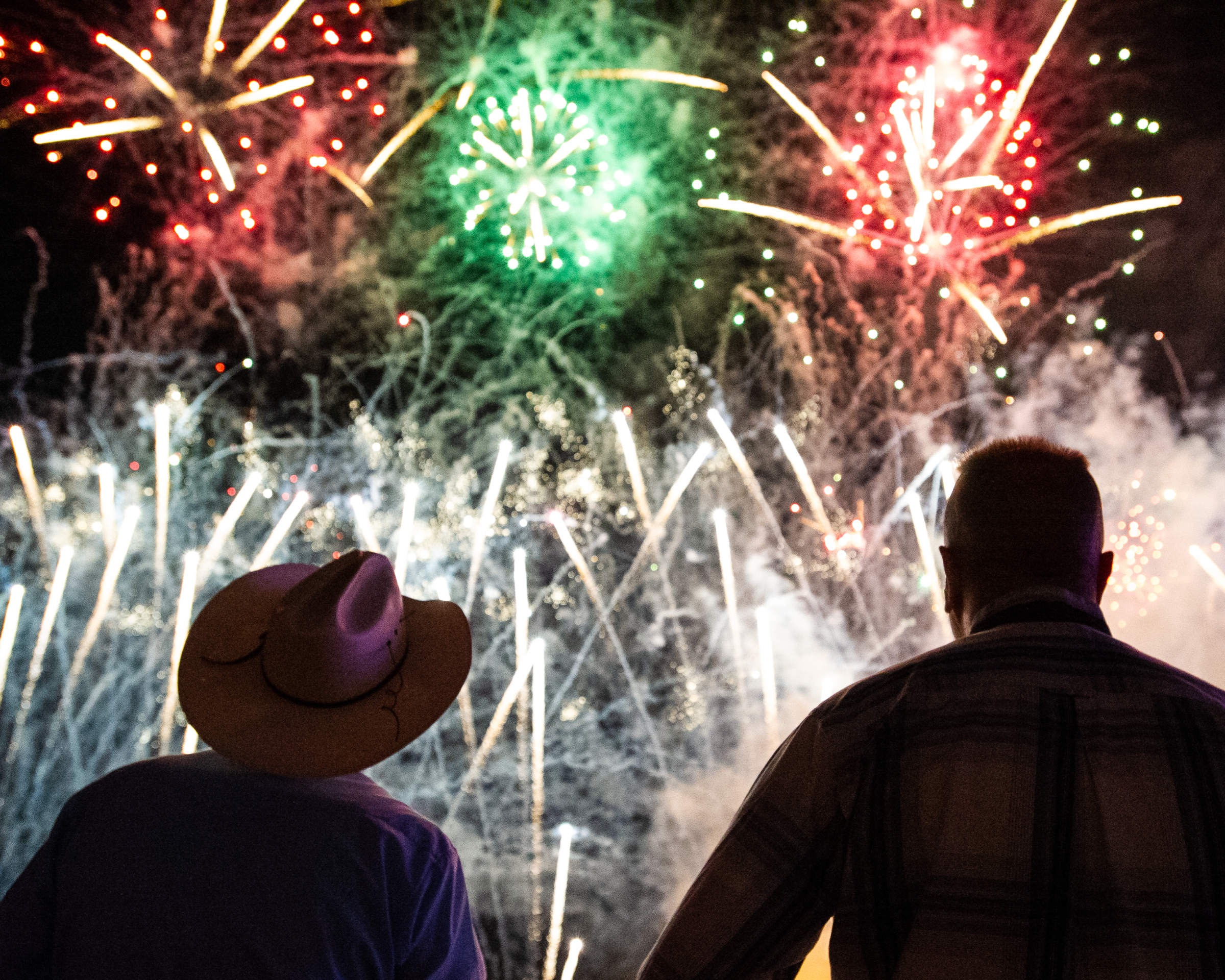 2 people watching a display of fireworks