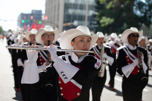 CalgarWoman playing the flute in the Stampede Showband performing downtown at the Stampede Parade