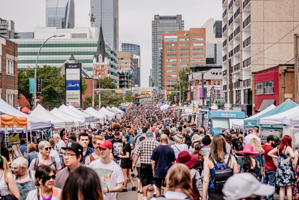 large crowd exploring vendors on 4th street during Lilac Festival