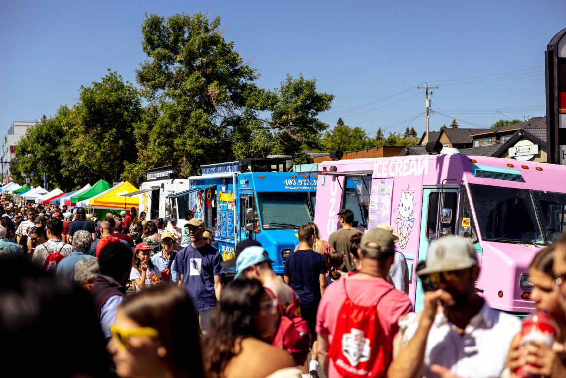 crowds of people ordering from food trucks at Marda Gras Street Festival