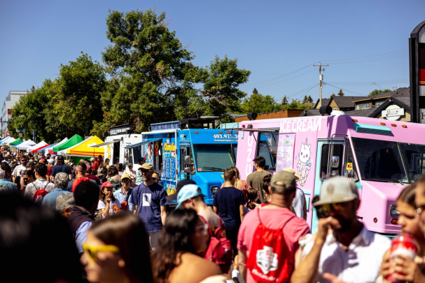 crowds of people ordering from food trucks at Marda Gras Street Festival