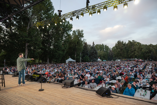Headliner performing comedy on a stage to a crowd