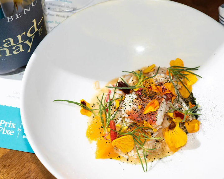 Gourmet plate of food and bottle of wine