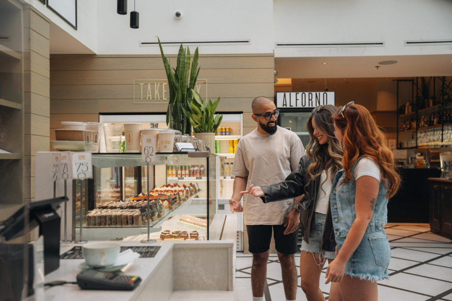 Two female and one male inside Alforno Bakery Cafe on a summer day