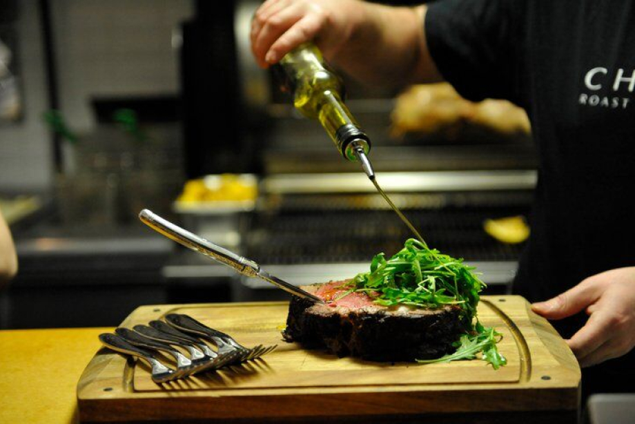 Chef preparing a steak at Charcut Roast House in Calgary