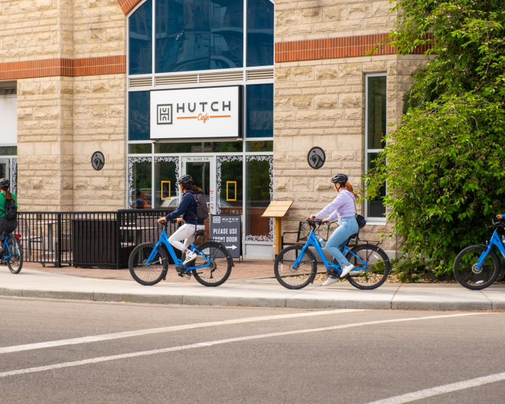 Food Bike Tour group cycling past Hutch Café in Calgary