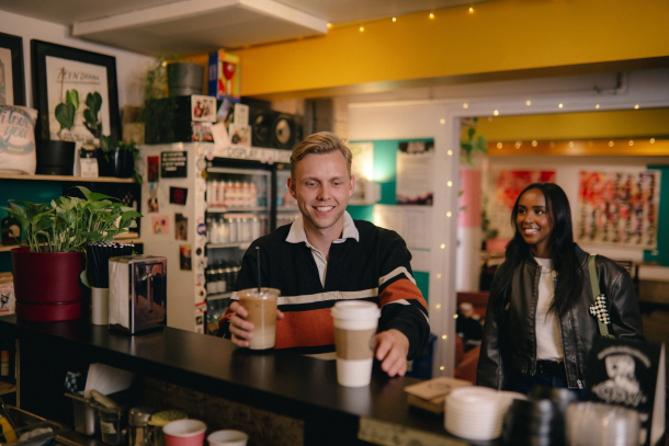 couple grabbing coffees inside I Love You Coffee Shop