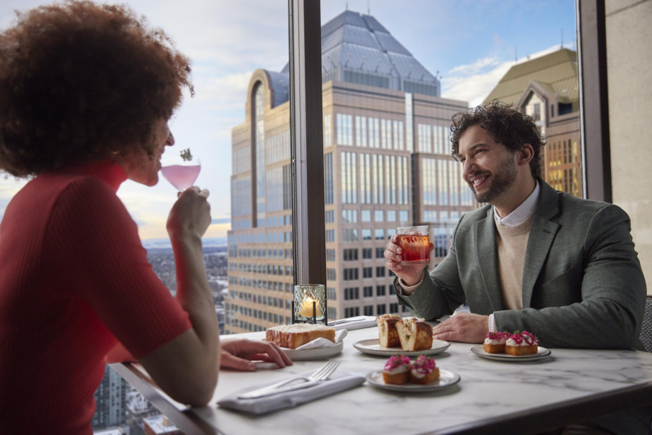 couple dining at Major Tom beside panoramic skyline views