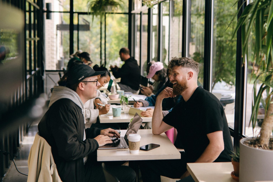 friends sitting inside the solarium dining area at Neighbour Coffee in Altadore