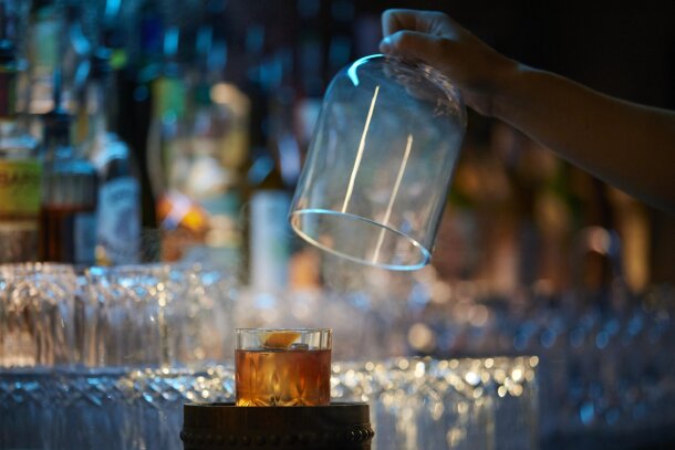 A cocktail being revealed at Proof.