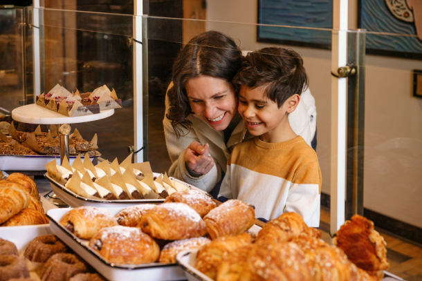 A mom and young child look at the baking options at the Sidewak Citizen Bakery in Calgary