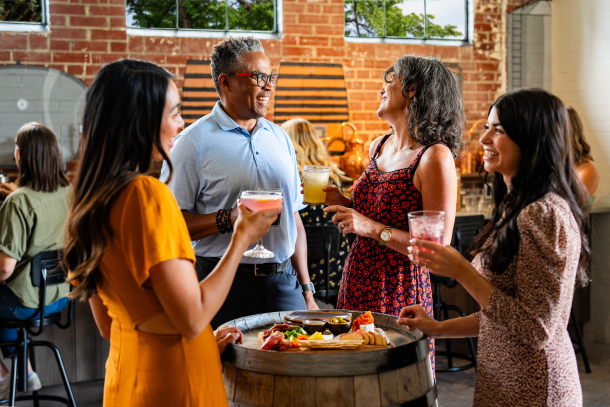 group of 4 enjoy drinks and appetizers at Veranda in the Currie Barracks