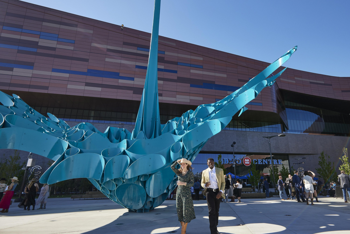 Two people walking in front of the BMO centre