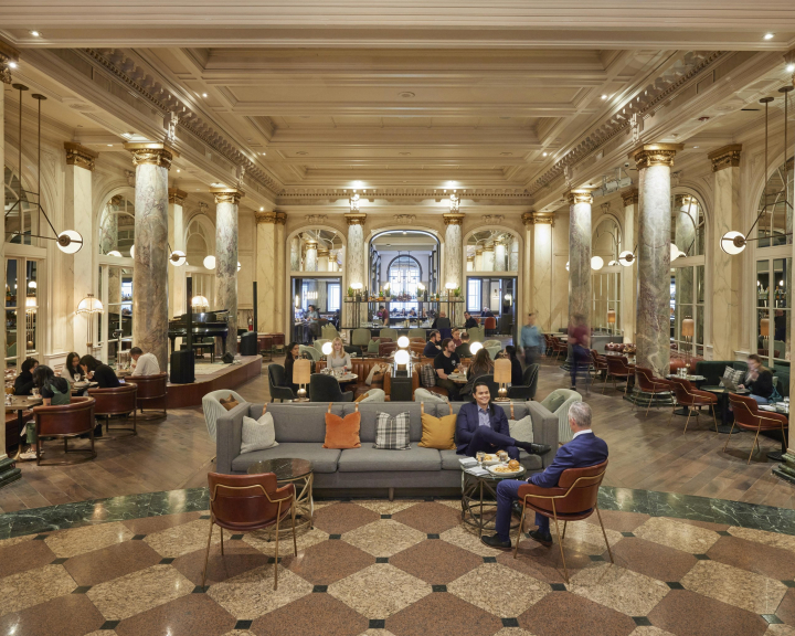 Two business people hanging out on the lobby couches at the Fairmont Palliser Hotel.
