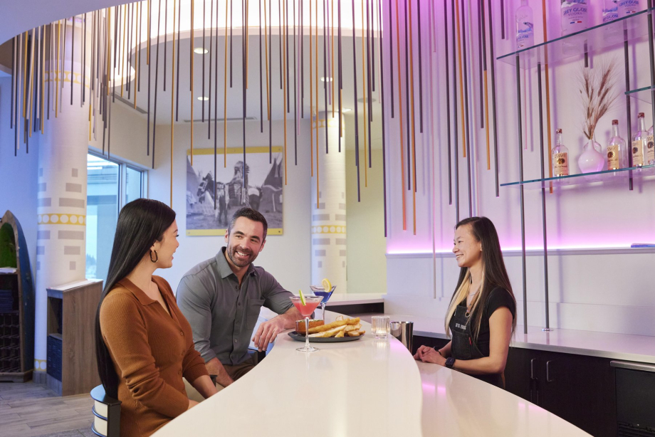 Couple enjoying welcome drinks and snacks in the lobby at Grey Eagle Resort & Casino
