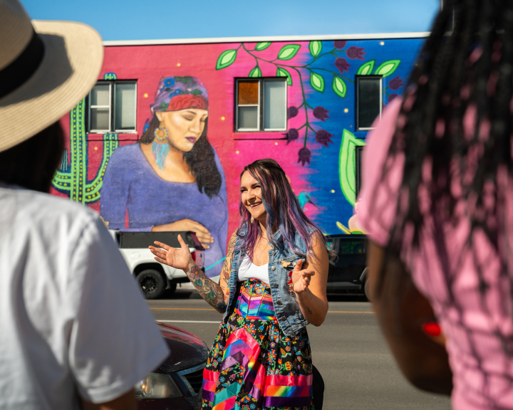 Mackenzie guides a group; sharing knowledge of the Indigenous art work on the walk with Zuc'min Guiding