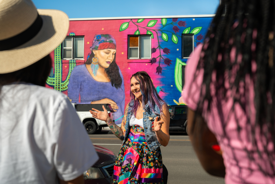 Mackenzie guides a group; sharing knowledge of the Indigenous art work on the walk with Zuc'min Guiding