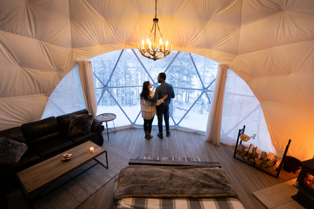 Couple looking out window of Camping Dome