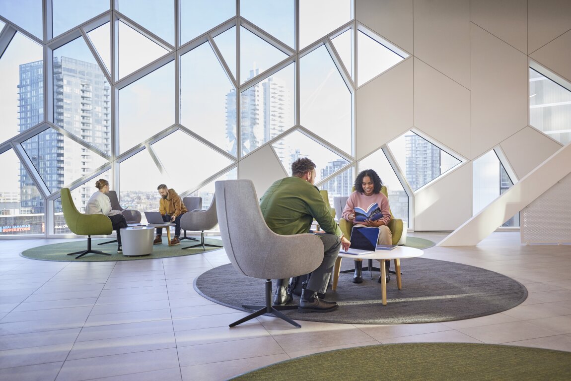 People sitting indoors and reading at the Calgary Central Library