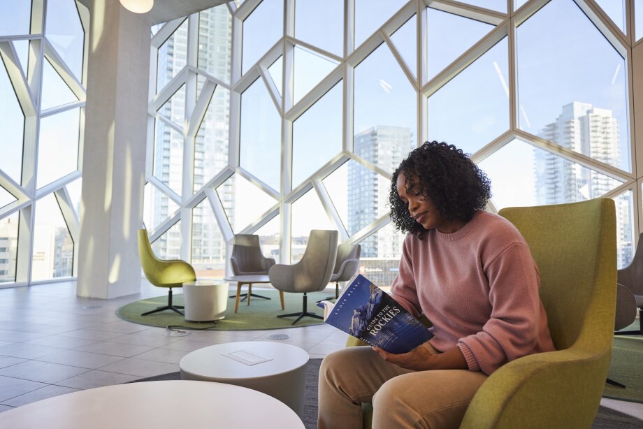 a woman reading a book at Calgary Public Library