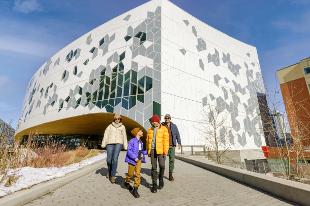 family walking in front of Calgary's central library
