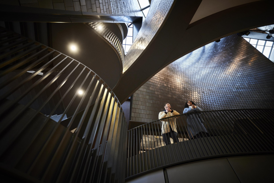 couple admires the interior architecture of Studio Bell